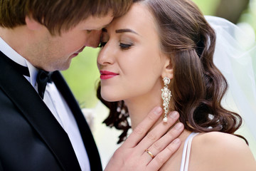 Wedding couple on the nature is hugging each other