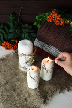huggie candles next to autumn sweaters and rowan