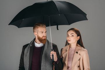 fashionable couple with umbrella