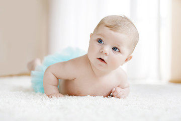 Adorable baby girl on white background wearing turquoise tutu skirt. © Irina Schmidt