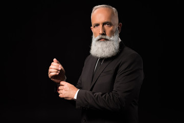 businessman adjusting cufflinks