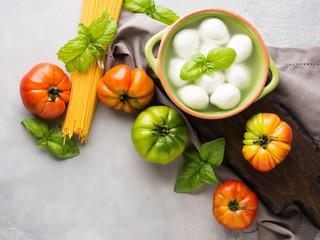 Italian food tomato mozzarella still life on gray rustic background. Traditional products