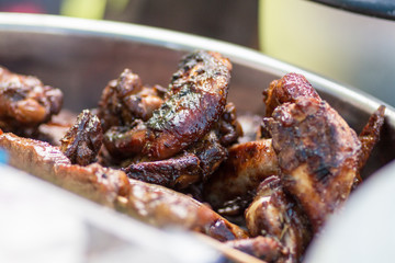 Char grilled chicken roasted over a open fire in a garden at daytime in the summer