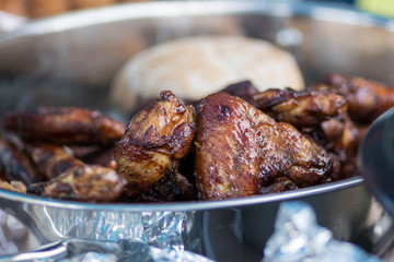 Char grilled chicken roasted over a open fire in a garden at daytime in the summer