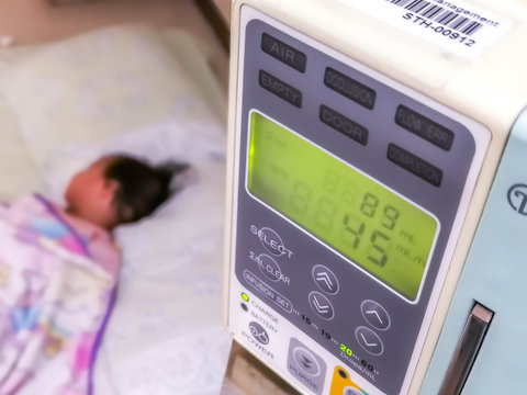 Childen has sick rest on bed in hospital with saline intravenous (iv), Medical equipment concept.Editorial
