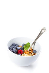 Granola with fresh organic raspberries and blueberries. Healthy breakfast