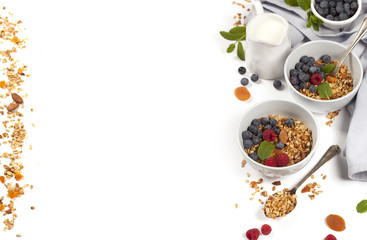 Obraz na płótnie Canvas Healthy breakfast - Homemade granola, honey, milk and berries