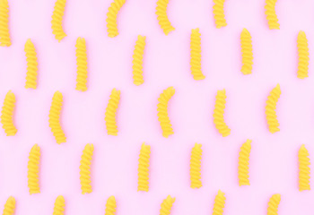 Uncooked italian pasta on pink trendy background.