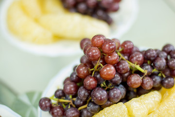 delicious  fruit , grapes, dragon fruit , melon  on the white bowl , healthy food for everybody with copy space