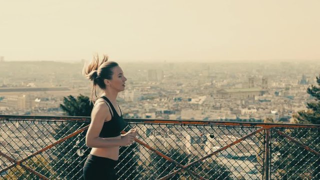 Woman running. Morning runner on the street with beautiful city view in Paris under sunlight.