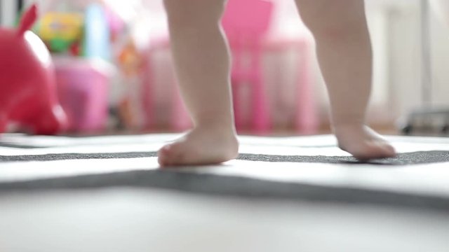 Close-up of a toddler's foot jumping on the carpet.