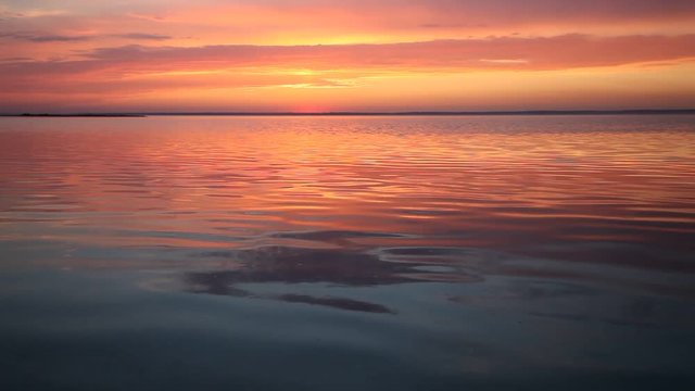 Ocean wave water surface with rising sun reflection. Florida, USA