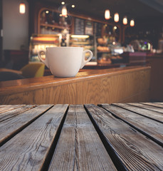 White cup of coffee at the cafe table