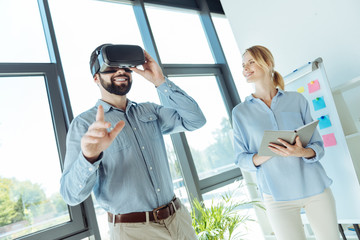 Young man trying out new VR headset in the office