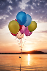 Colorful Balloons On The Bridge At The Sea And A Beautiful Sunset. Birthday Party Balloons