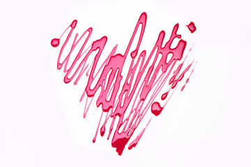 Symbol of love painted with pink polish on white surface