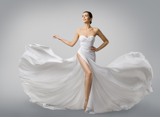 Woman White Dress, Fashion Model Bride in Long Silk Wedding Gown, Elegant Flying Fabric, Fluttering...