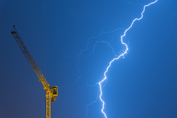 crane struck by lightning, powerful thunderbolt  - Powered by Adobe