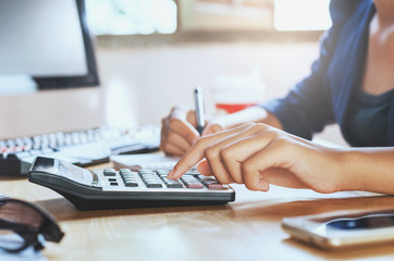businessman working on desk office using calculator business financial accounting concept