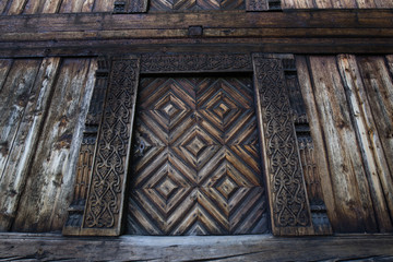 Carved door and doorjamb of an old 'Loft' storehouse of a traditional Norwegian farmstead from the Telemark region