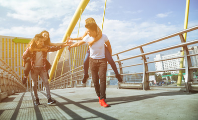 Two couples friends having fun and walking in the city