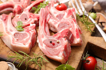 raw lamb chop on wooden board