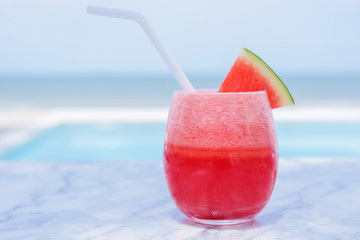 Watermelon spinning on a table, the background is the beach
