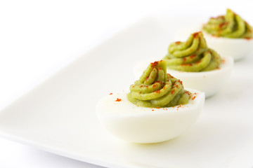 Stuffed eggs with guacamole isolated on white background

