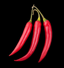 Three red chili peppers on black background