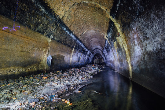Flooded by wastewater sewage collector. Dirty sewer tunnel under city