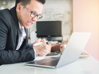 Business man is feel strain or tired and angry with him work in office