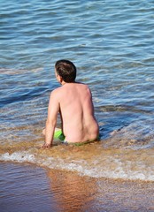 Fototapeta premium Man in meditation on the shore, unrecognizable person