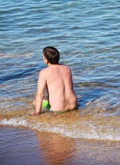 Man in meditation on the shore, unrecognizable person