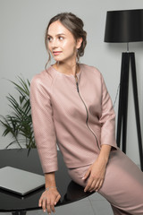 A portrait of a business women in the meeting room with computer having a break. Conception of the business, negotiations, time management, career opportunities, elegant dress code and life style.