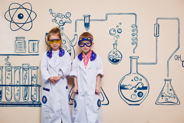 small children do chemical experiments. cheerful science,
