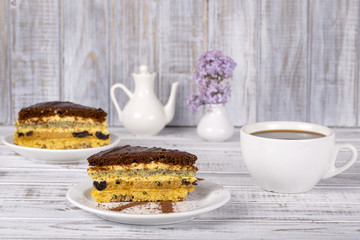 Chocolate cake from biscuit dough with poppy seed, prune, walnuts and cup coffee