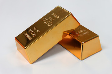 Two gold bars lay against together