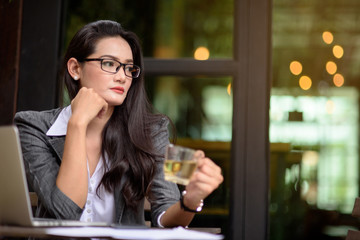 Young business woman planning new sales and marketing strategies at office garden during her tea break.  Business concept.