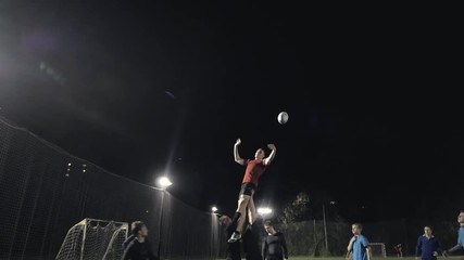 Football coach training and teaching a football player. Soccer or rugby players outdoor match, athelete sport event, mens playing