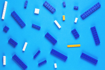 Toys construction bricks pattern on blue background