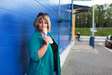 blonde woman eat ice cream outdoor