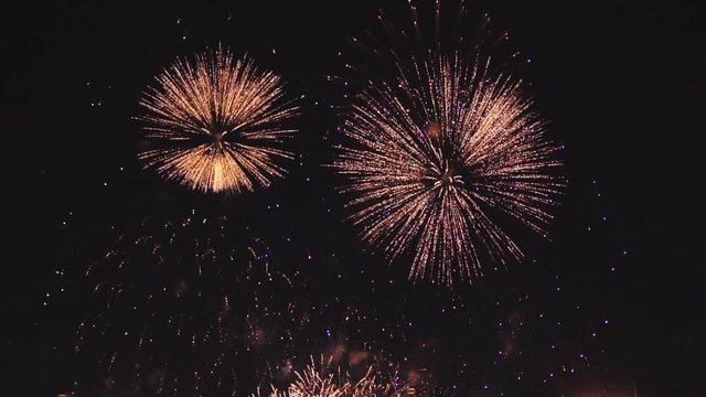 holiday fireworks in slow motion on the black sky background. Shot at 100fps.