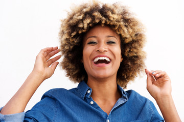 Close up african american female laughing against white wall