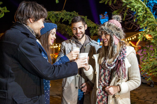 Friends drinking punch at Christmas Market