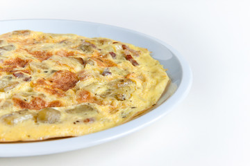 closeup of italian savory omelette on white background, typical dish with eggs, potatoes and bacon