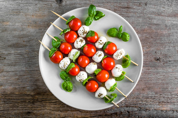 Caprese salad - skewer with tomato, mozzarella and basil, italian food and healthy vegetarian diet...