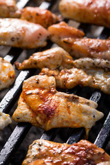 Selective focus on chicken breasts frying on the barbecue grill