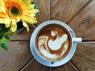  How to make a queen of swan Lake picture of coffee latte art style on wooden table with vivid yellow flower background.