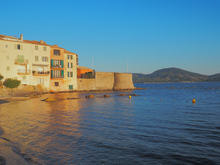 Fototapeta na wymiar The buildings along the coastline of Saint Tropez, on an early summer morning.