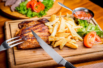 Beef steak with pepper sauce and Grilled vegetables on cutting board  dark wooden background